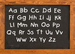 education school day care black chalkboard with letters capital and small letters