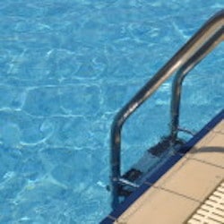 Vibrant Swimming Pool Side With Ladder